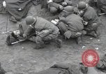Image of Medics tend to wounded U.S. soldiers on beach Normandy France, 1944, second 23 stock footage video 65675022977