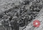 Image of Medics tend to wounded U.S. soldiers on beach Normandy France, 1944, second 32 stock footage video 65675022977