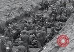 Image of Medics tend to wounded U.S. soldiers on beach Normandy France, 1944, second 38 stock footage video 65675022977