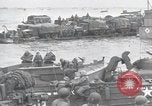 Image of Medics tend to wounded U.S. soldiers on beach Normandy France, 1944, second 41 stock footage video 65675022977