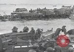 Image of Medics tend to wounded U.S. soldiers on beach Normandy France, 1944, second 45 stock footage video 65675022977