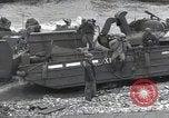 Image of Medics tend to wounded U.S. soldiers on beach Normandy France, 1944, second 53 stock footage video 65675022977