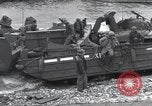Image of Medics tend to wounded U.S. soldiers on beach Normandy France, 1944, second 54 stock footage video 65675022977
