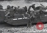 Image of Medics tend to wounded U.S. soldiers on beach Normandy France, 1944, second 56 stock footage video 65675022977