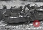 Image of Medics tend to wounded U.S. soldiers on beach Normandy France, 1944, second 57 stock footage video 65675022977