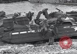 Image of Medics tend to wounded U.S. soldiers on beach Normandy France, 1944, second 58 stock footage video 65675022977