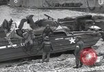 Image of Medics tend to wounded U.S. soldiers on beach Normandy France, 1944, second 60 stock footage video 65675022977