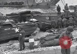 Image of Medics tend to wounded U.S. soldiers on beach Normandy France, 1944, second 62 stock footage video 65675022977