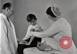 Standbild Arzt vaccinates Boy Detroit Michigan USA, 1936, aus Sekunde 45 historischem Filmmaterial Videoclip 65675023153