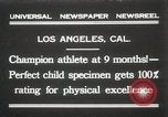 Image of man performs stunts on 9 months baby Los Angeles California USA, 1931, second 1 stock footage video 65675023610