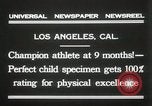 Image of man performs stunts on 9 months baby Los Angeles California USA, 1931, second 6 stock footage video 65675023610