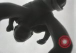 Image of man performs stunts on 9 months baby Los Angeles California USA, 1931, second 18 stock footage video 65675023610