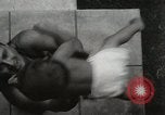 Image of man performs stunts on 9 months baby Los Angeles California USA, 1931, second 20 stock footage video 65675023610