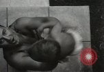 Image of man performs stunts on 9 months baby Los Angeles California USA, 1931, second 22 stock footage video 65675023610