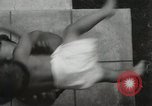 Image of man performs stunts on 9 months baby Los Angeles California USA, 1931, second 23 stock footage video 65675023610