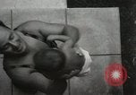Image of man performs stunts on 9 months baby Los Angeles California USA, 1931, second 24 stock footage video 65675023610