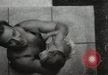 Image of man performs stunts on 9 months baby Los Angeles California USA, 1931, second 25 stock footage video 65675023610