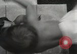 Image of man performs stunts on 9 months baby Los Angeles California USA, 1931, second 26 stock footage video 65675023610