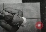 Image of man performs stunts on 9 months baby Los Angeles California USA, 1931, second 27 stock footage video 65675023610