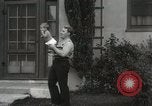 Image of man performs stunts on 9 months baby Los Angeles California USA, 1931, second 28 stock footage video 65675023610