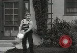 Image of man performs stunts on 9 months baby Los Angeles California USA, 1931, second 29 stock footage video 65675023610
