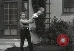 Image of man performs stunts on 9 months baby Los Angeles California USA, 1931, second 31 stock footage video 65675023610