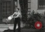 Image of man performs stunts on 9 months baby Los Angeles California USA, 1931, second 32 stock footage video 65675023610