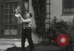Image of man performs stunts on 9 months baby Los Angeles California USA, 1931, second 33 stock footage video 65675023610