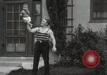 Image of man performs stunts on 9 months baby Los Angeles California USA, 1931, second 34 stock footage video 65675023610