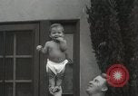 Image of man performs stunts on 9 months baby Los Angeles California USA, 1931, second 35 stock footage video 65675023610