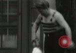 Image of man performs stunts on 9 months baby Los Angeles California USA, 1931, second 38 stock footage video 65675023610