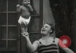 Image of man performs stunts on 9 months baby Los Angeles California USA, 1931, second 40 stock footage video 65675023610