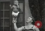 Image of man performs stunts on 9 months baby Los Angeles California USA, 1931, second 41 stock footage video 65675023610