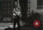Image of man performs stunts on 9 months baby Los Angeles California USA, 1931, second 42 stock footage video 65675023610