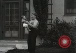 Image of man performs stunts on 9 months baby Los Angeles California USA, 1931, second 43 stock footage video 65675023610