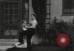 Image of man performs stunts on 9 months baby Los Angeles California USA, 1931, second 44 stock footage video 65675023610