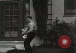 Image of man performs stunts on 9 months baby Los Angeles California USA, 1931, second 45 stock footage video 65675023610