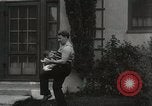 Image of man performs stunts on 9 months baby Los Angeles California USA, 1931, second 46 stock footage video 65675023610