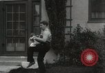 Image of man performs stunts on 9 months baby Los Angeles California USA, 1931, second 47 stock footage video 65675023610