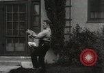 Image of man performs stunts on 9 months baby Los Angeles California USA, 1931, second 48 stock footage video 65675023610
