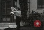 Image of man performs stunts on 9 months baby Los Angeles California USA, 1931, second 49 stock footage video 65675023610