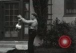 Image of man performs stunts on 9 months baby Los Angeles California USA, 1931, second 50 stock footage video 65675023610