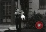 Image of man performs stunts on 9 months baby Los Angeles California USA, 1931, second 51 stock footage video 65675023610
