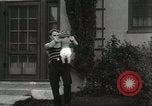 Image of man performs stunts on 9 months baby Los Angeles California USA, 1931, second 52 stock footage video 65675023610