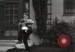 Image of man performs stunts on 9 months baby Los Angeles California USA, 1931, second 53 stock footage video 65675023610