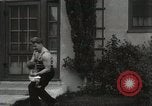 Image of man performs stunts on 9 months baby Los Angeles California USA, 1931, second 54 stock footage video 65675023610