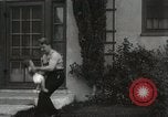 Image of man performs stunts on 9 months baby Los Angeles California USA, 1931, second 55 stock footage video 65675023610