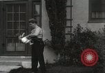 Image of man performs stunts on 9 months baby Los Angeles California USA, 1931, second 56 stock footage video 65675023610
