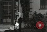 Image of man performs stunts on 9 months baby Los Angeles California USA, 1931, second 57 stock footage video 65675023610
