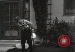Image of man performs stunts on 9 months baby Los Angeles California USA, 1931, second 58 stock footage video 65675023610